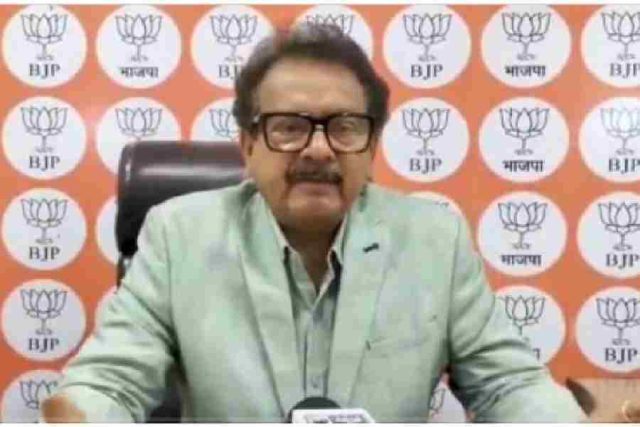 Satyapal Singh Baghel seated, speaking to the media in front of a Bharatiya Janata Party backdrop