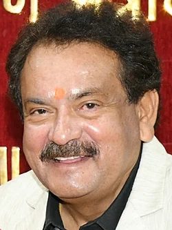 Close portrait of Satyapal Singh Baghel smiling, in a white jacket